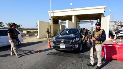 Iraqi security men stand guard at a checkpoint at the entrance to the Baghdad International Airport. EPA
