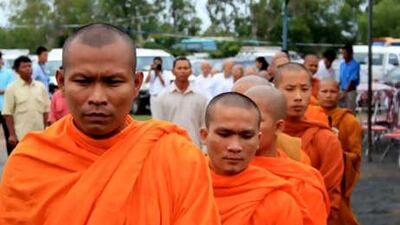 Buddhist monks line up yesterday to enter the Extraordinary Chambers of the Courts of Cambodia, an international tribunal where the former Khmer Rouge leader known as "Duch" was found guilty of war crimes and crimes against humanity.