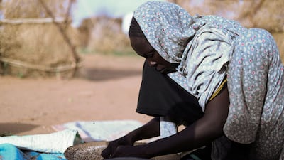 A displaced Sudanese woman prepares food at a shelter in Tawila, North Darfur. Reuters