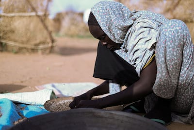 A Sudanese mother of five prepares food at a shelter in Darfur. Reuters