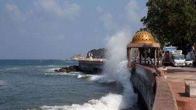 Strong waves break over a seaside promenade in the Omani capital Muscat. AFP