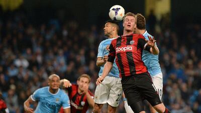 West Bromwich Albion midfielder Chris Brunt is challenged by Manchester City striker Edin Dzeko, right, and Manchester City defender Gael Clichy on Monday. Paul Ellis / AFP / April 21, 2014