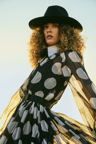 Dress, Dh17,700; and hat, Dh2,200, both from Dolce & Gabbana. Photo: Ben Cope at MMG