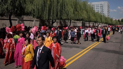 Participants and spectators make their way away from on Kim Il Sung square following a military parade and mass rally in Pyongyang. AFP