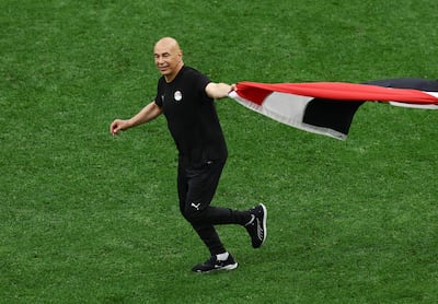 Egypt coach Hossam Hassan runs on to the pitch waving his country's flag after beating New Zealand 3-1 in a Group G match. Reuters