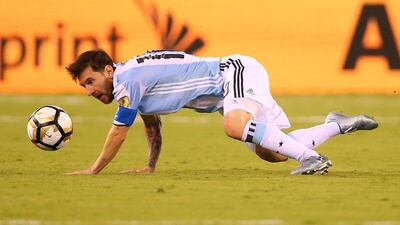 Lionel Messi is tripped up by Mauricio Isla. (Mike Stobe/Getty Images/AFP)