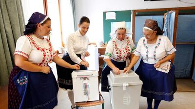 Hungarian women wearing traditional costumes attend a referendum on EU migrant quotas in Veresegyhaz, Hungary, October 2, 2016. REUTERS/Bernadett Szabo