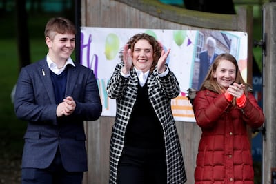 The family of army veteran Captain Tom Moore, daughter Hannah Ingram-Moore and Grandchildren Benji and Georgia applaud outside his home on his 100th birthday, following the outbreak of the coronavirus disease (COVID-19), in Marston Moretaine, Britain, April 30, 2020. REUTERS/Paul Childs