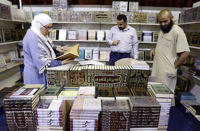 Visitors look at the spiritual literature presented at the 19th Amman International Book Fair, in Amman, Jordan, in 2019. EPA