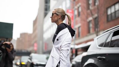 Celine Aagaard is seen attending the Tibi show during New York Fashion Week wearing a white coat with black Champion hoodie. Matthew Sperzel / Getty Images