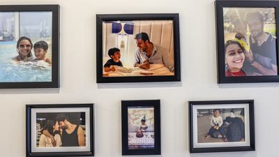 Family photos on the wall of the home, which also has a laundry room and three bathrooms