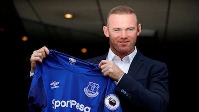 Everton's Wayne Rooney poses with the club shirt after the press conference.