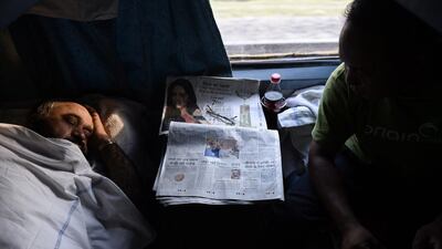 An Indian man asleep in an air-conditioned compartment on board the Kalka Mail train.