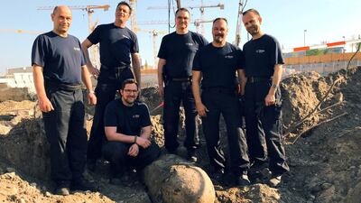 Bomb disposal experts pose next to the 500-kilogram Second World War bomb found near the main train station in Berlin, on April 20, 2018. Courtesy @polizeiberlin_e /Twitter/Handout via Reuters.