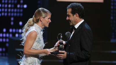 Tony Shalhoub, right, accepts the award for leading actor in a musical for his work in "The Band's Visit" from presenter Kelli O'Hara. Michael Zorn / Invision / AP