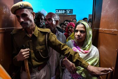 Indian voters stand in queue to cast their vote at a local polling station during Rajasthan's Legislative Assembly election, in Jodhpur on December 7, 2018. AFP