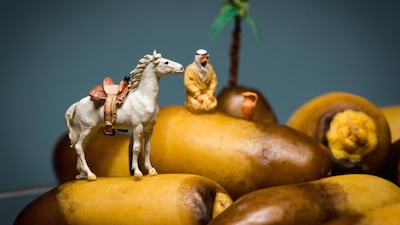 Omar Maree Humaid arranges figurines and props to create elaborate ‘sets’, such as a kandoura-clad man and his horse atop a heap of dates. Courtesy Omar Maree Humaid
