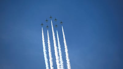 The Al Fursan aerobatic team light up the skyline of Abu Dhabi. Khushnum Bhandari / The National