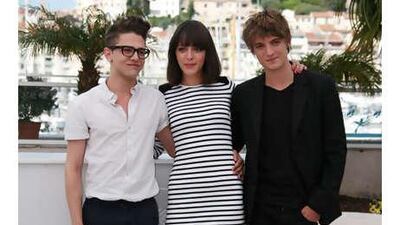 Monia Chokri wears Breton stripes at a photocall in front of the marina during the Cannes Film Festival. She is flanked by fellow actors Xavier Dolan, left, and Niels Schneider.