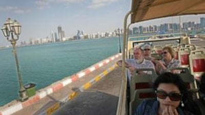 Big Bus passengers ride past the breakwater during their tour of Abu Dhabi.