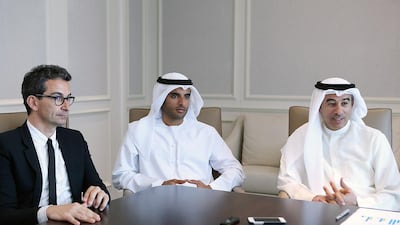 From left: Federico Marchetti, chief executive of Yoox Net-A-Porter Group, Rashid Alabbar, chairman of the joint venture between Symphony Investments and Yoox Net-A-Porter, and Mohamed Alabbar, chairman of Symphony Investments, discuss their joint venture during an interview with The National. Satish Kumar / The National