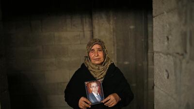 Najah Abed Al Dayem, 50, holds a picture of her husband, who was killed during the most recent conflict.