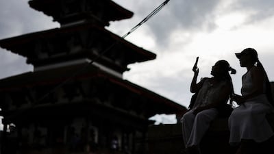 A woman uses her phone at Basantapur Durbar Square in Kathmandu, Nepal after the government announced it will close all social media not registered with it. Reuters
