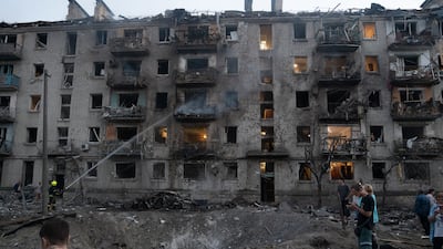 Residents gather at the site of a Russian missile strike on a residential area in Kyiv. EPA