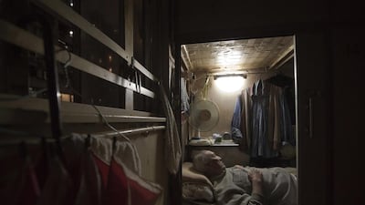 Tse Chu, a retired waiter, sleeps in his little cubicle home in Hong Kong where rents and home prices have steadily risen and are now at or near all-time highs.