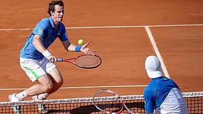The British player Andy Murray, left, beat Juan Ignacio Chela of Argentina in straight sets to set up a semi-final with world No 1 Rafael Nadal.