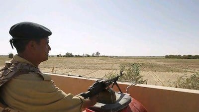 An Iraqi border policeman mans a machine gun at the Abu Kamal-Qaim border crossing, the main border post between Iraq and Syria. Al Qaim and its neighbouring Syrian counterpart Albu Kamal are on a strategic supply route for smugglers, gun-runners and now insurgents aiming to join the rebellion.