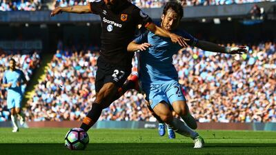 Hull City midfielder Ahmed Elmohamady, left, vies with Manchester City's David Silva. City beat Hull 3-1 in Manchester. Geoff Caddick / AFP