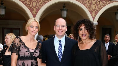 Charlene Wittstock, in a blush and black lace dress, with Prince Albert II of Monaco and actress Viktor Lazlo, attends a reception during the 2007 Monte Carlo Television Festival on June 13, 2007. Getty Images
