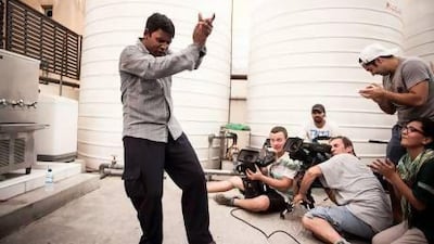 Yaqoobi belts out a Bengali hit for the camera. Courtesy of Veritas Films/ Photo by Siddharth Siva