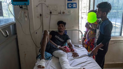 Gura Pallay, 24, in hospital. He said he had been watching a train pass the one in which he was sitting when he heard loud screeching and suddenly found himself hurtling through the air outside. AP
