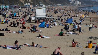 People enjoy the warm weather at Bournemouth beach, on England's south coast. Reuters