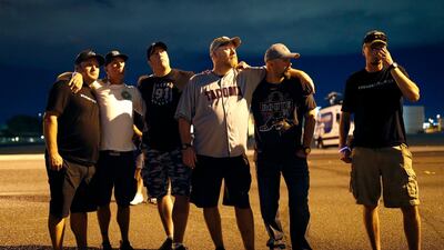 Survivors return to the scene at the shuttered site of a country music festival on the first anniversary of the incident. AP