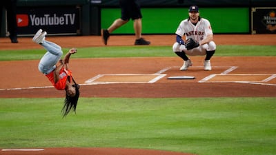 American gymnast Simone Biles performs a flip after throwing the ceremonial first pitch prior to Game 2 of the 2019 World Series between the Houston Astros and Washington Nationals at Minute Maid Park in Texas on October 23. Getty