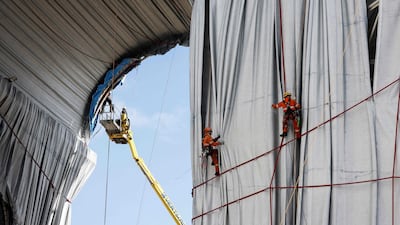 For 16 days, the famous landmark was cocooned in 25,000 square metres of recyclable, silvery blue polypropylene fabric. AFP
