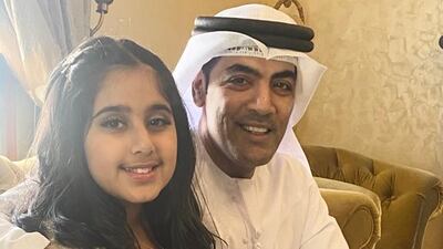 Nassir Al Kashwani, 45, a Sharjah Department of Finance employee, with his daughter Hajar, 8, at their home. Photo: Nassir Al Kashwani