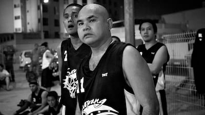 Two members of the Black team react to a point being scored by the Blue team.