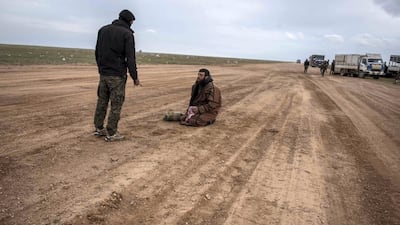 A suspected ISIS member is questioned by a member of the Syrian Democratic Forces. Campbell MacDiarmid / The National