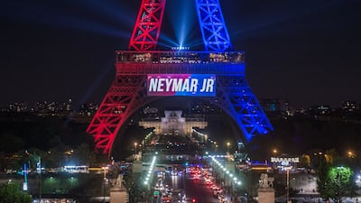 The Eiffel Tower is illuminated in red and blue, the colours of the Paris Saint-Germain soccer team, to celebrate the arrival of the Brazilian striker Neymar. Christophe Petit Tesson / EPA