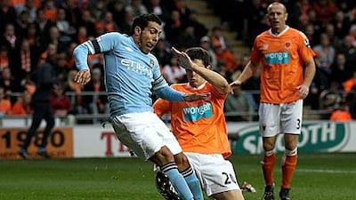 Carlos Tevez gets in front of Blackpool’s Craig Cathcart to score Manchester City’s opening goal.