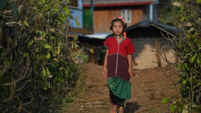 A Kayan tribesgirl wearing a stack of bronze neck coils. Once the preserve of intrepid travellers as it languished under junta rule, Myanmar is now a tourist draw.