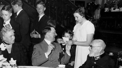 German Chancellor Adolf Hitler, center, gives his autograph to the great-granddaughter of German industrialist Emil Kirdorf, seated at right, on the occasion of Kirdorf's 90th birthday in Berlin, Germany, April 8, 1937. Hitler presented Kirdorf with the