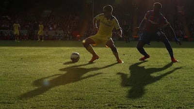Chelsea's Eden Hazard, left, dribbles away from Crystal Palace's Wilfried Zaha during Chelsea's 2-1 win over Palace at Selhurst Park in London on Saturday. Adrian Dennis / AFP