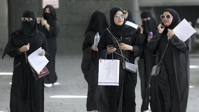 Saudi students walk at the exhibition to guide job seekers at Glowork Women's Career Fair in Riyadh, Saudi Arabia in 2018. Reuters