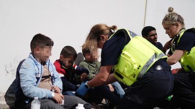 Young migrants are checked in Dungeness, Kent, England, after being rescued by an RNLI lifeboat from a small boat in the English Channel on August 16, 2023. PA / Getty Images