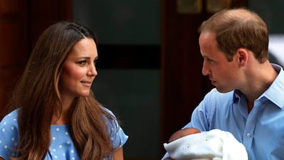 Britain's Prince William holds the Prince of Cambridge, Tuesday, July 23, 2013, as he and his wife Kate, Duchess of Cambridge pose for photographers. AP Photo / Lefteris Pitarakis